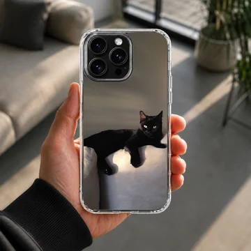 Black cat lounging in serene setting on phone case — Lifestyle