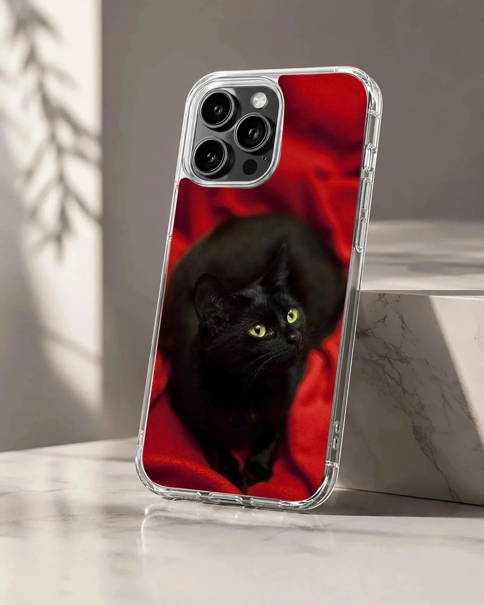 Black cat with green eyes on red background phone case