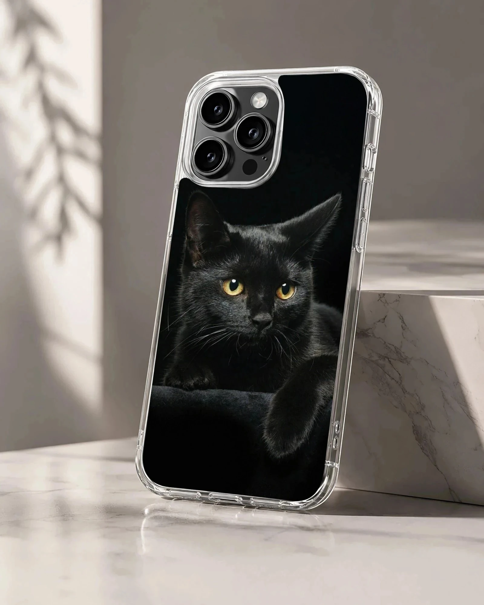 Serene black cat resting with intense gaze on phone case