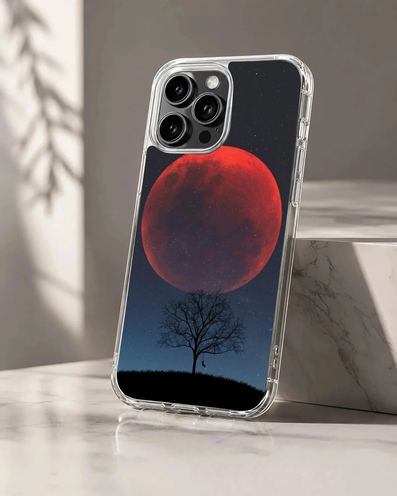 Blood Moon against a night sky with tree silhouette phone case.