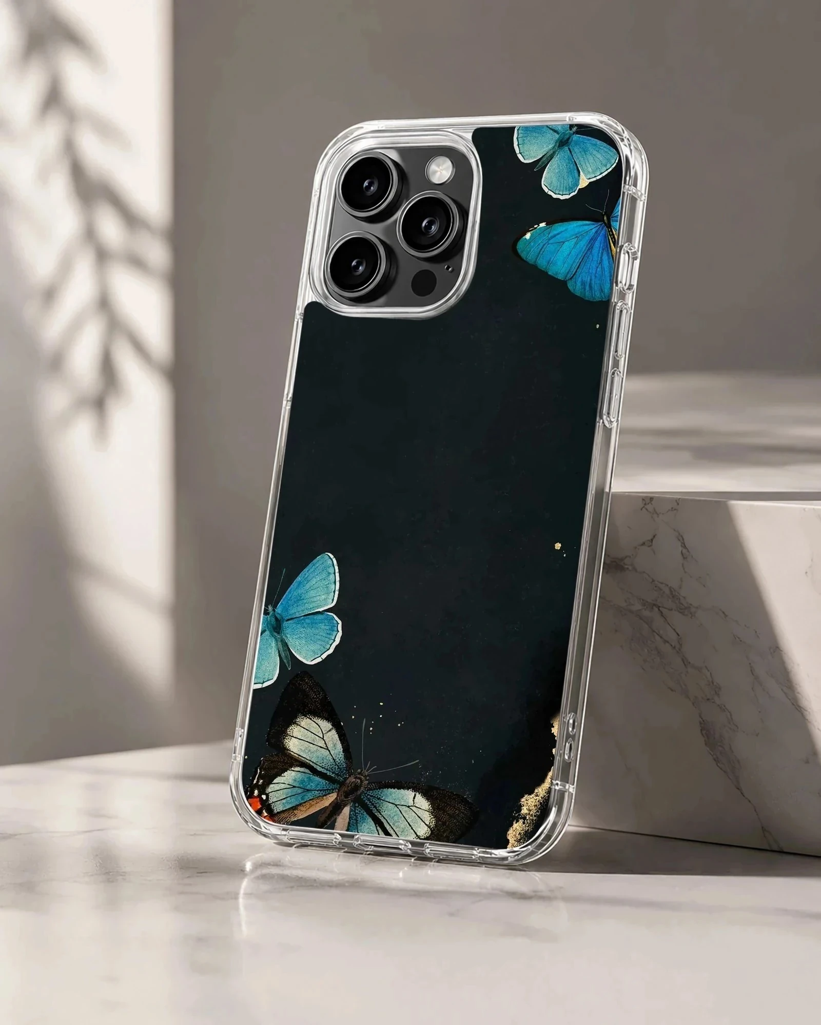 Phone case with a design of blue butterflies on a black background.