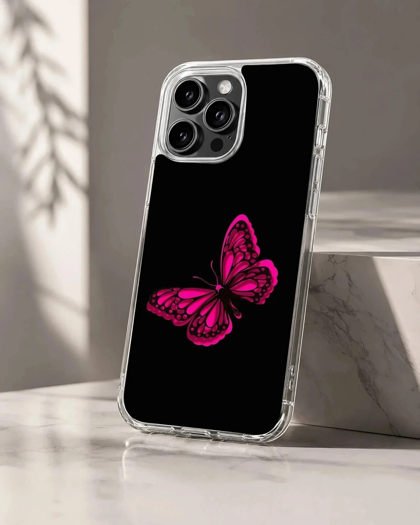 Phone case with a vibrant pink butterfly on a black background