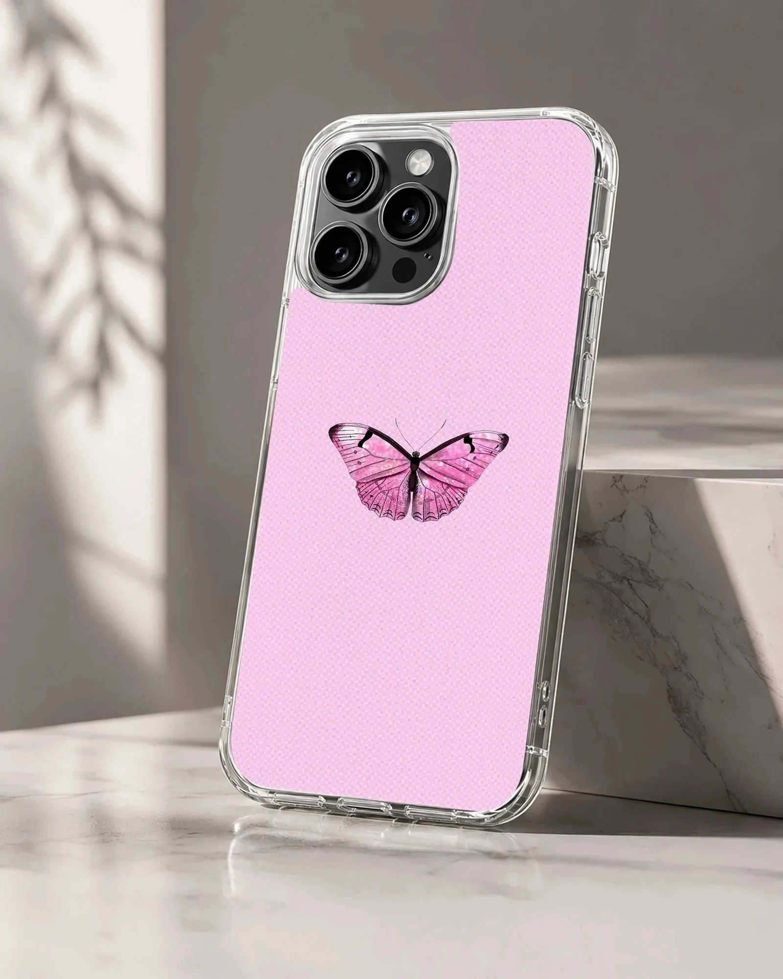 Pink butterfly on a phone case with a light pink background