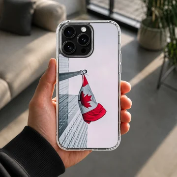 Canadian flag waving on a pole against an urban building backdrop on a phone case — Lifestyle