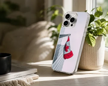 Canadian flag waving on a pole against an urban building backdrop on a phone case — Lifestyle