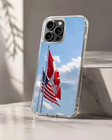 Canadian and American flags waving against a bright blue sky on a phone case