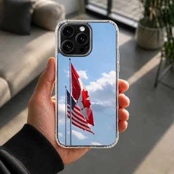 Canadian and American flags waving against a bright blue sky on a phone case — Lifestyle