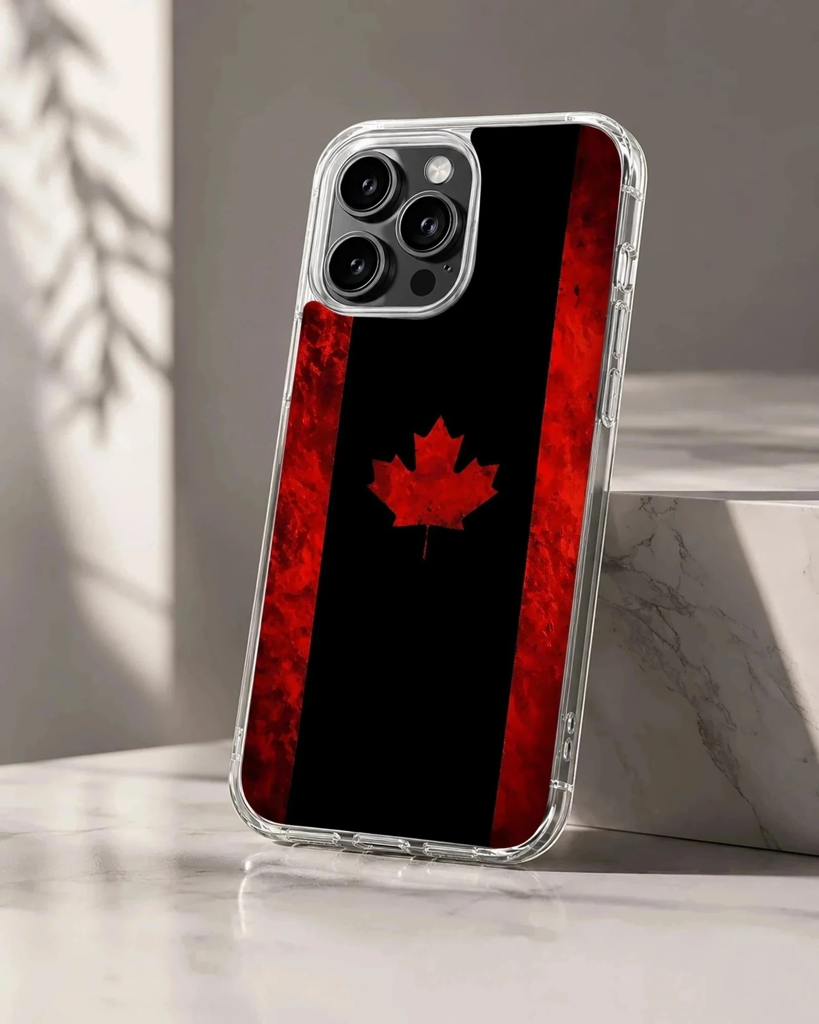 A stylized Canadian flag phone case featuring a bold red maple leaf set against a dark black and textured red background.