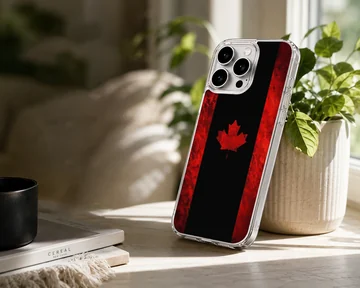 A stylized Canadian flag phone case featuring a bold red maple leaf set against a dark black and textured red background. — Lifestyle