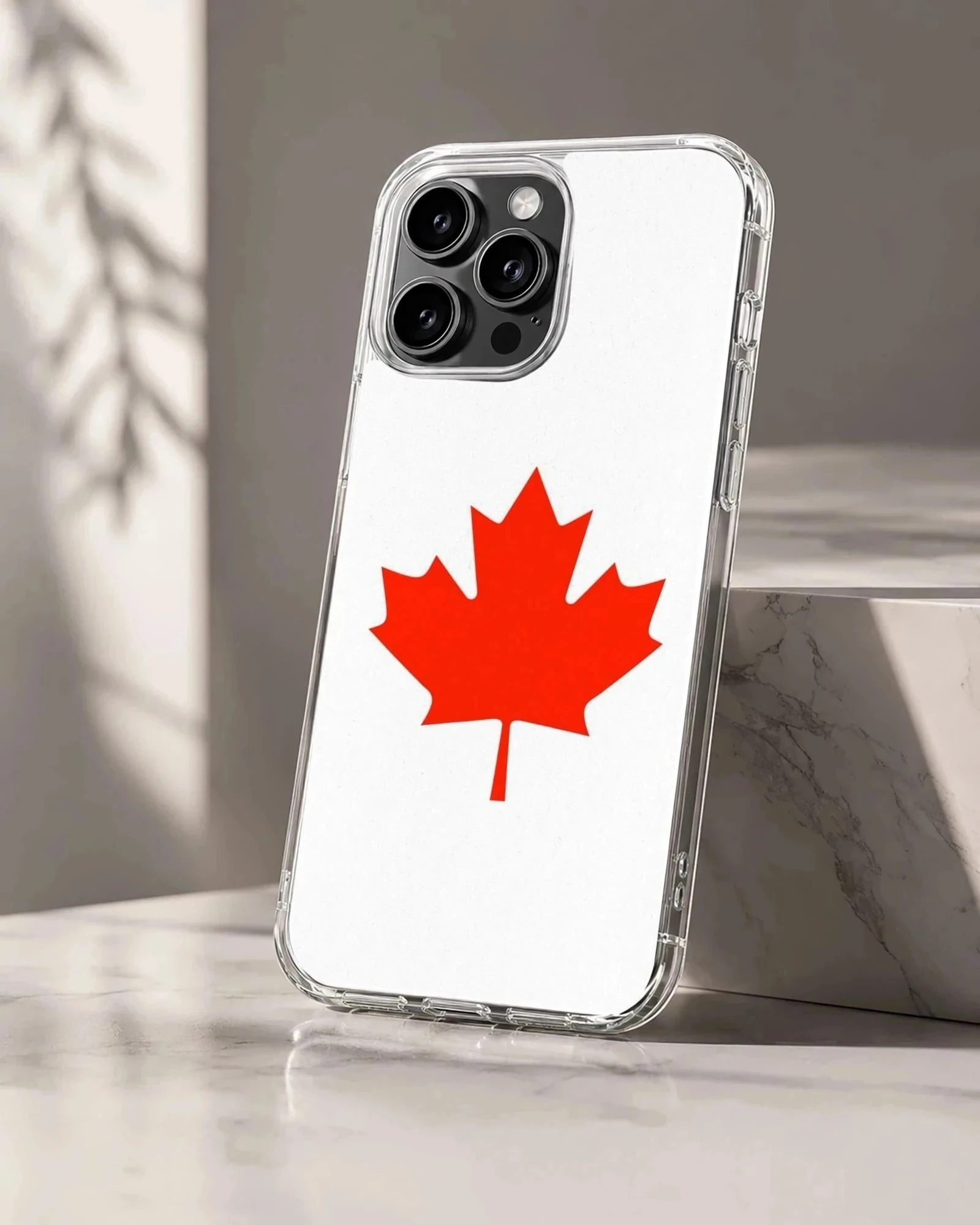 A minimalist white phone case featuring a bold red Canadian maple leaf illustration phone case