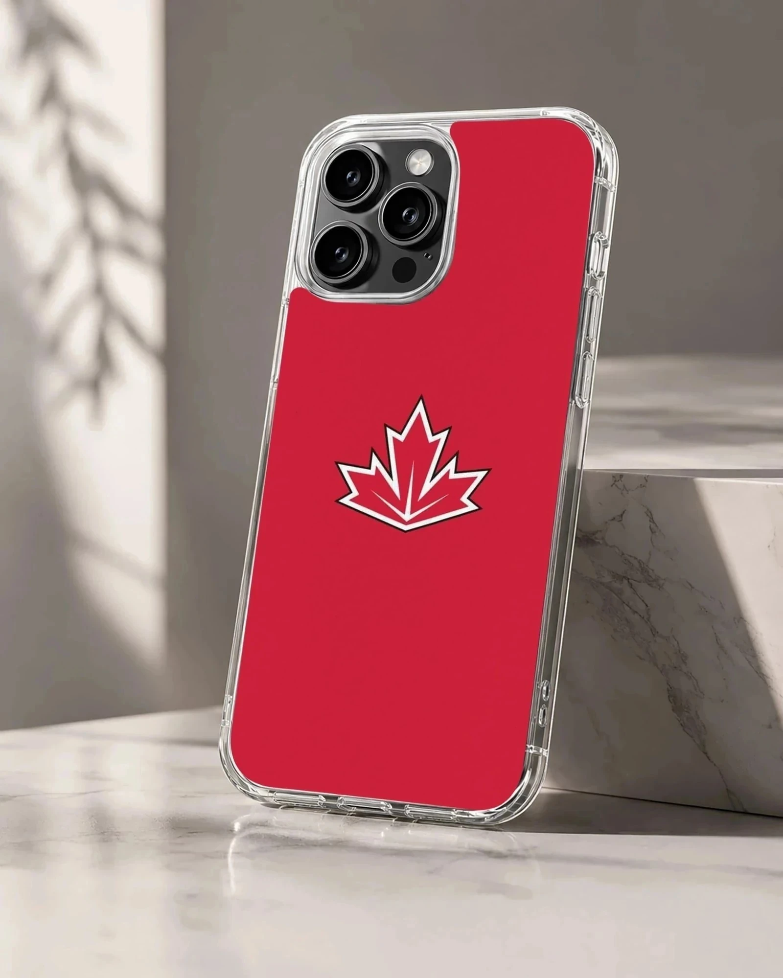 Vibrant red phone case featuring a stylized white and black bordered maple leaf symbol inspired by the Canadian flag