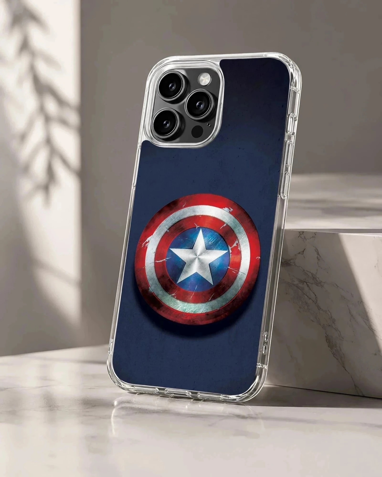 Weathered red, white, and blue superhero shield art on a phone case