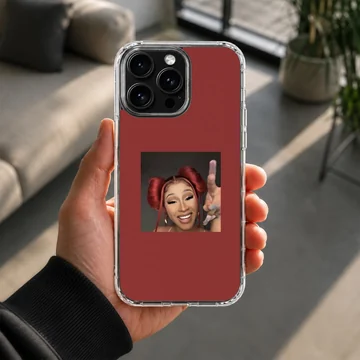 Portrait of Cardi B with red hair buns set against a rich red background on a phone case — Lifestyle
