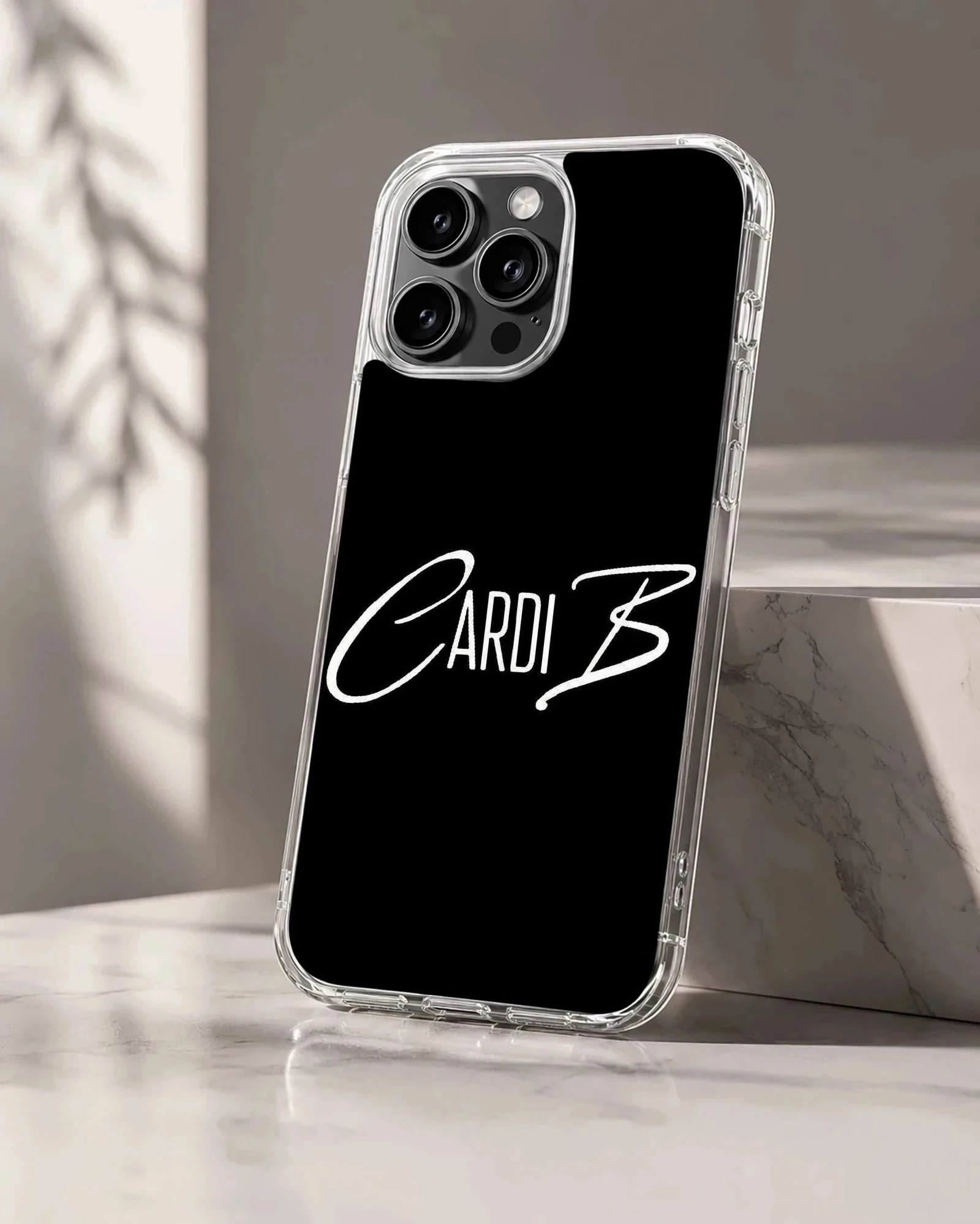 White signature typography spelling Cardi B on a solid black phone case