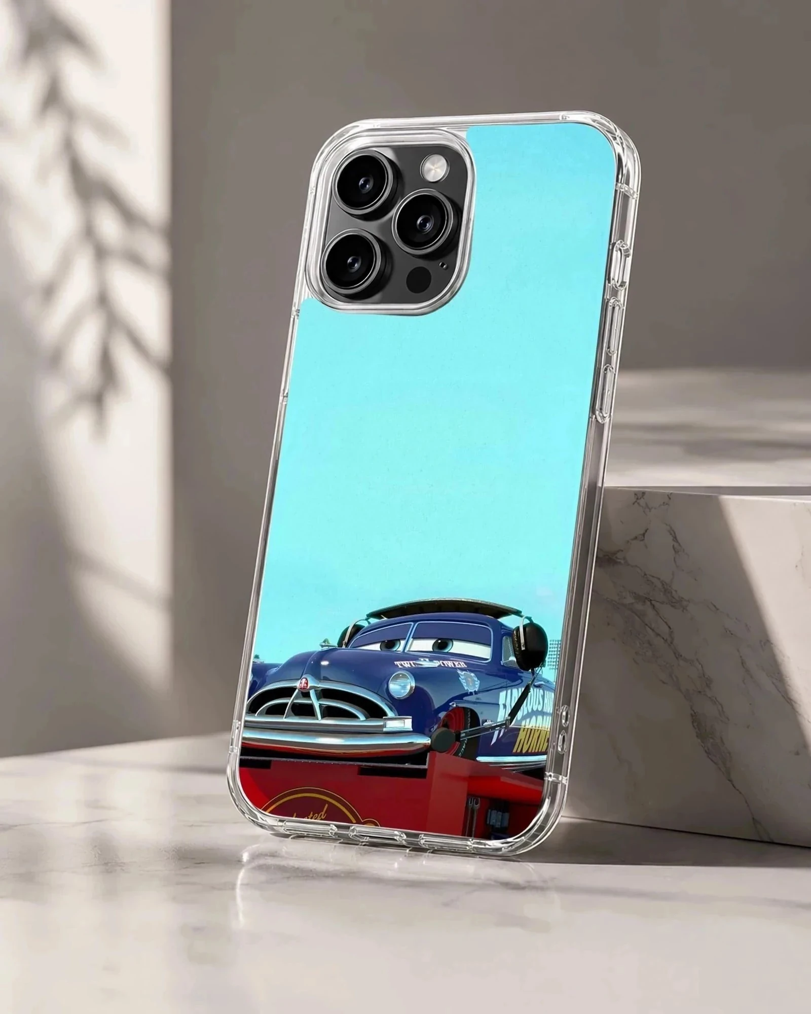 Vintage race car art in deep blue against a light blue sky on a phone case