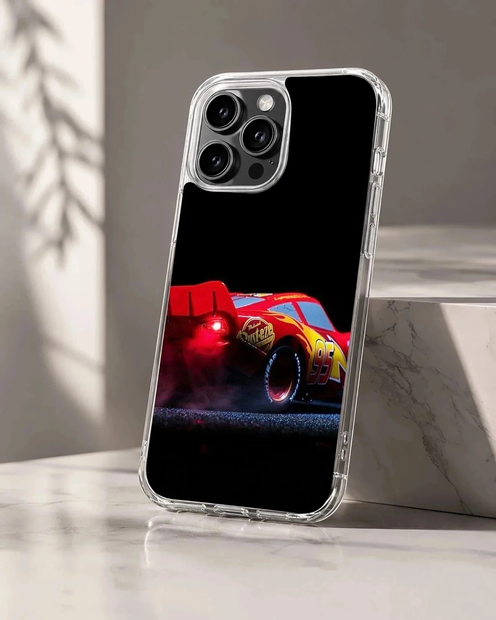 Red racing car captured mid-burnout against a black background on a phone case