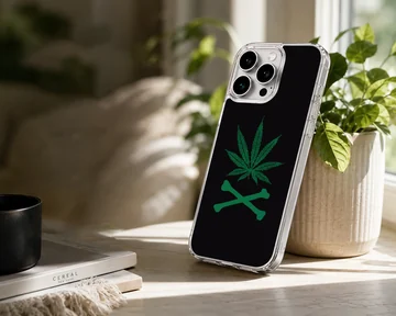 A black snap phone case featuring a green cartoon weed leaf above crossed bones phone case — Lifestyle