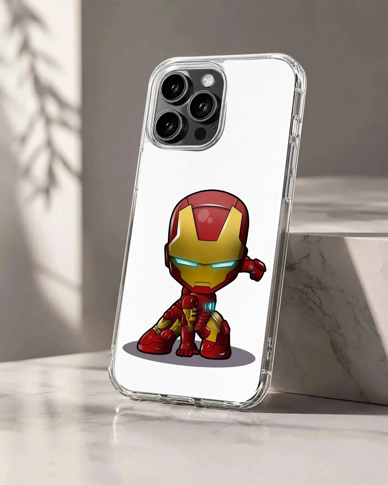 Chibi armored superhero character in a red and gold suit crouched on a phone case