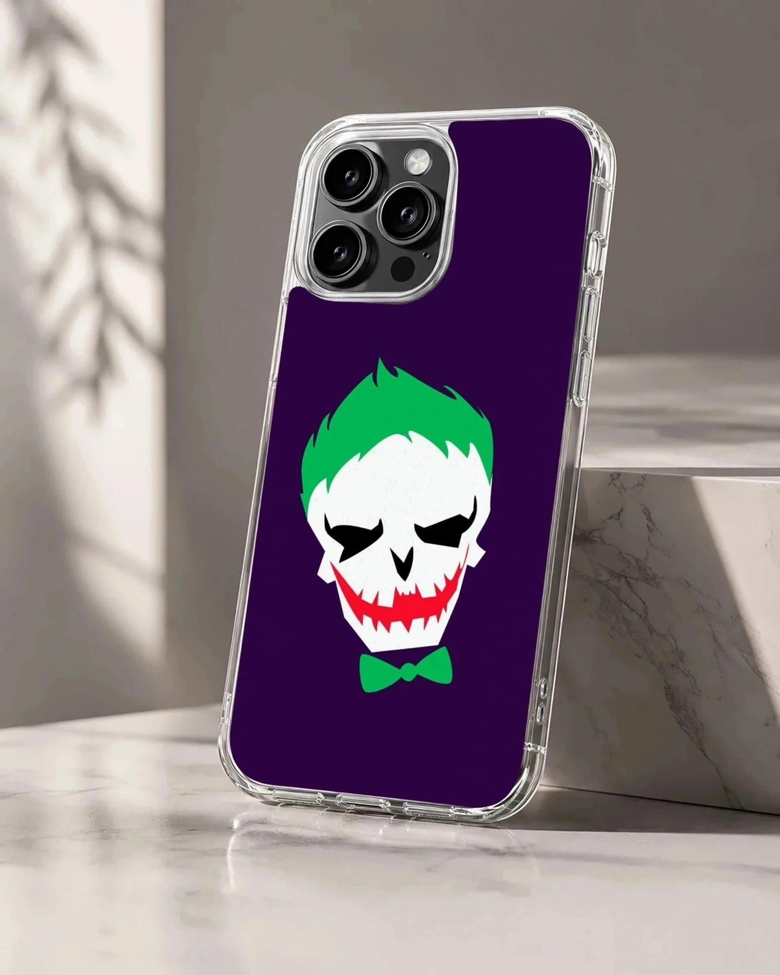 Jester skull cartoon art with green hair and red grin on a purple background phone case