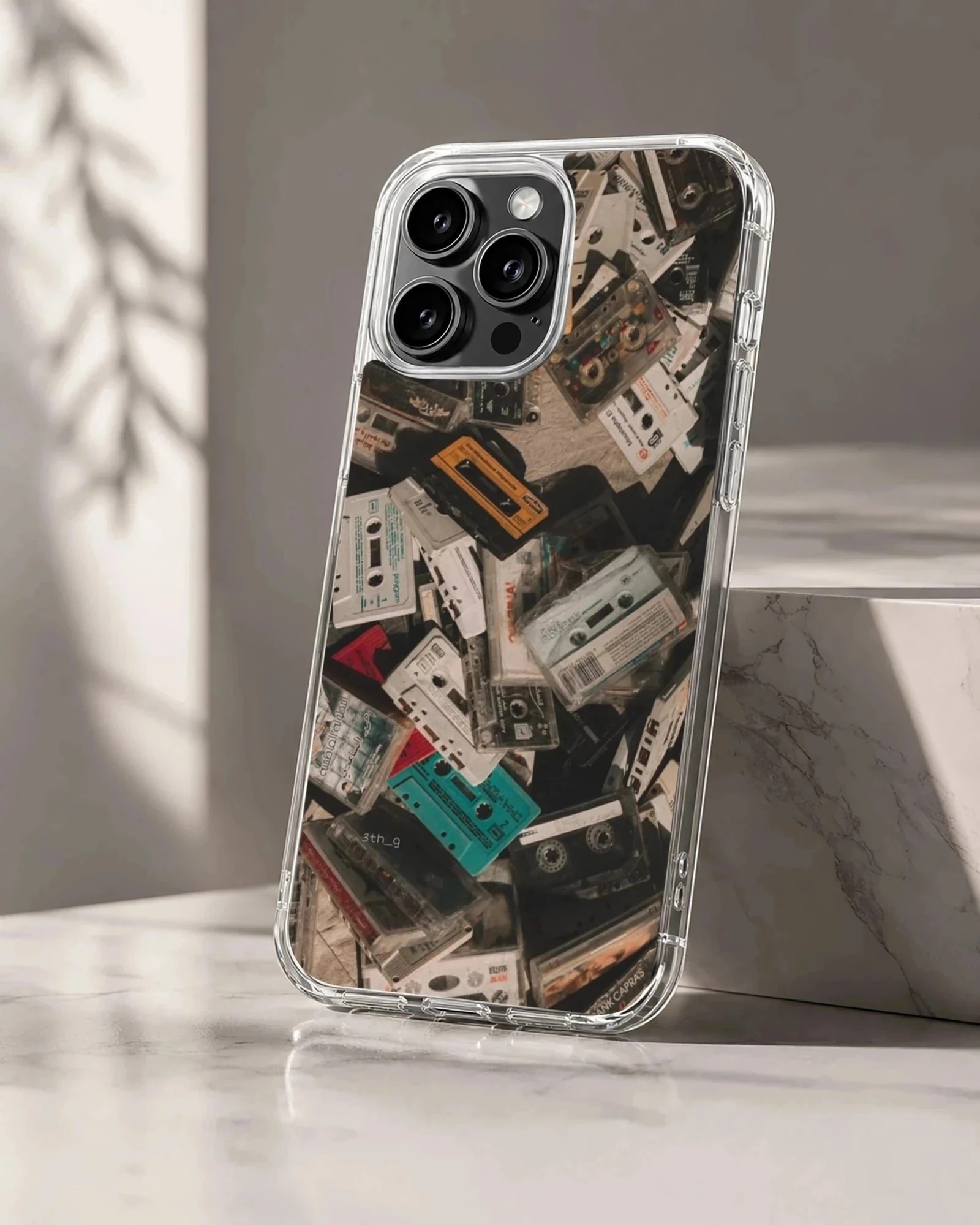 A collage print of vintage audio cassette tapes in various colors on a phone case