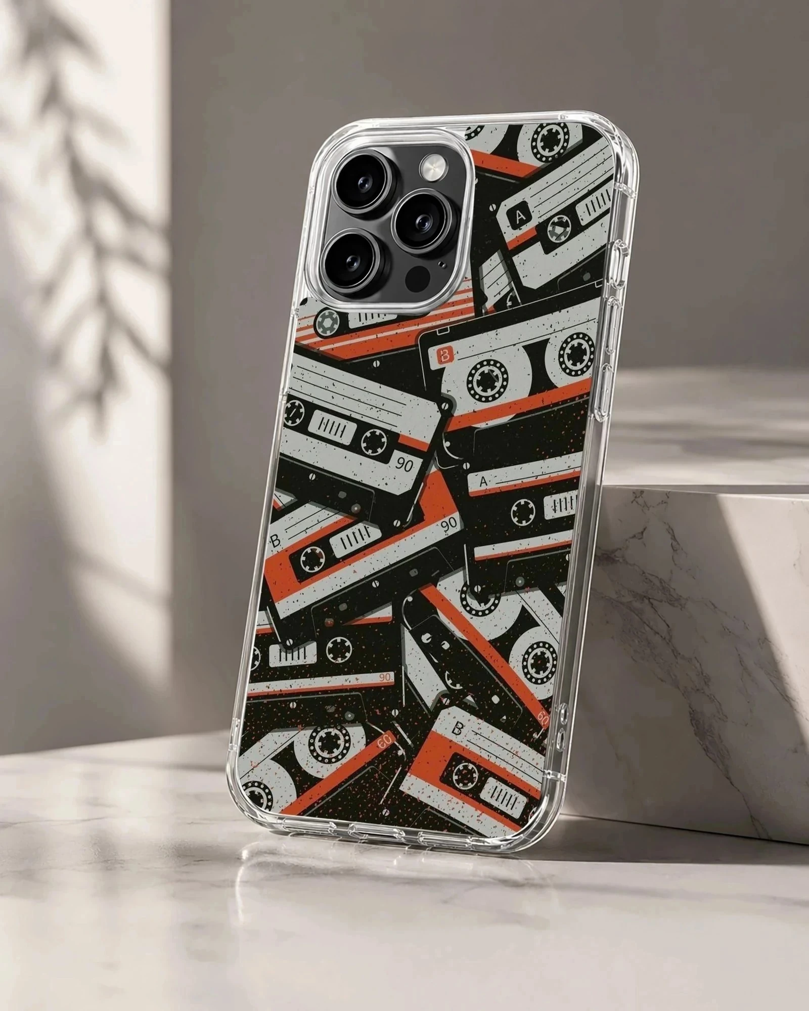A collage of vintage cassette tapes in black, white, and red on a phone case