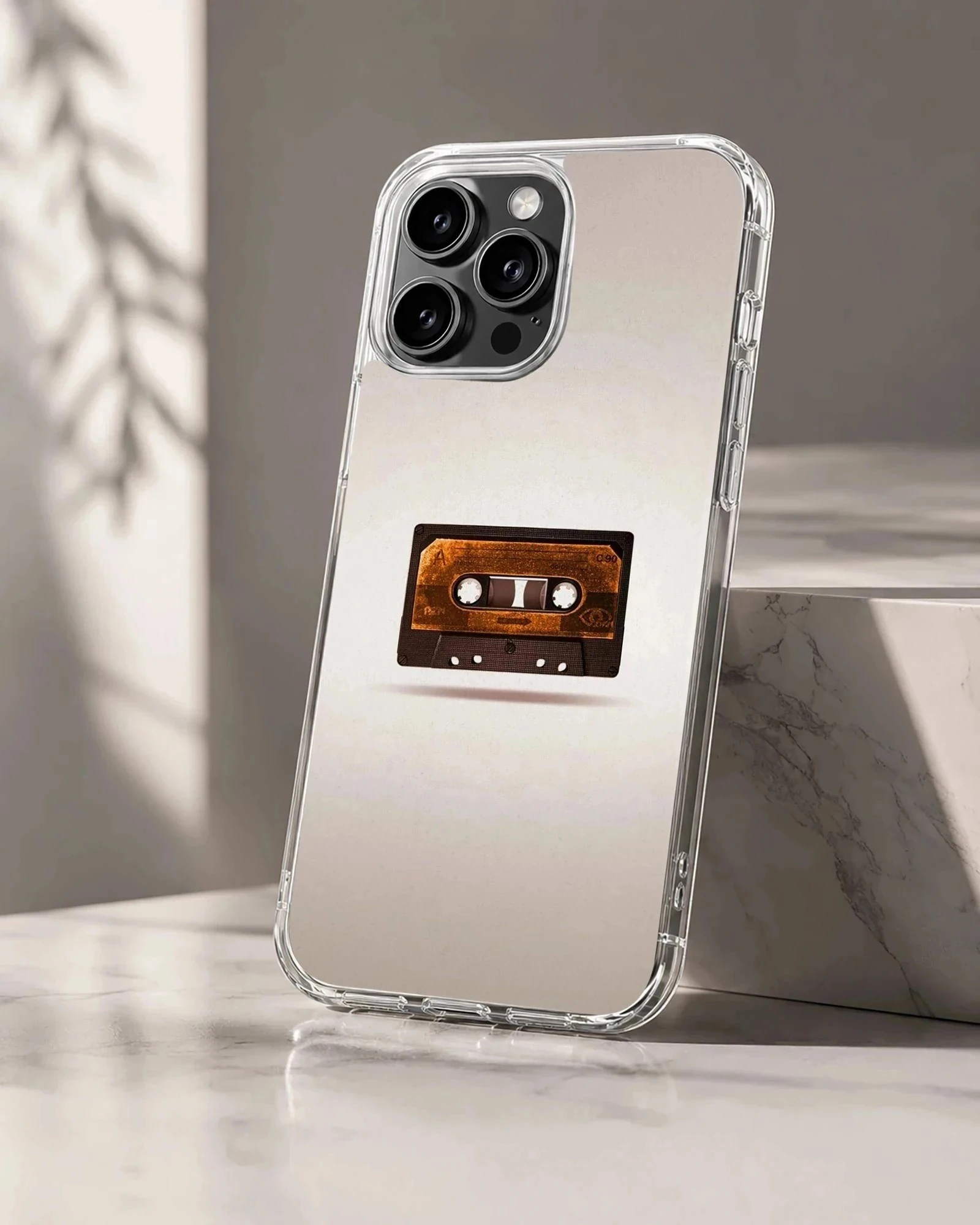 Close-up of a vintage brown cassette tape graphic centered on a phone case