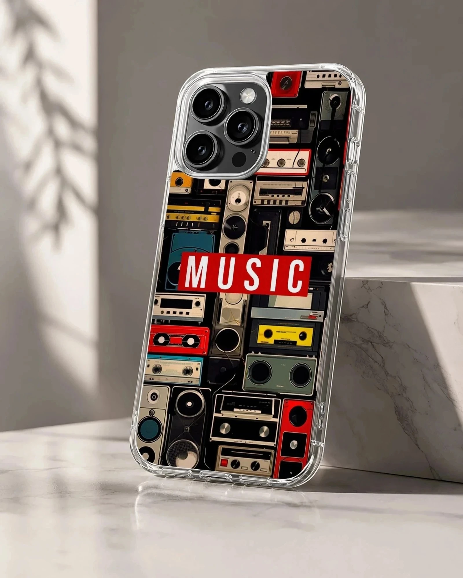 A collage of vintage cassette tapes and boomboxes with a bold red music label printed on a phone case