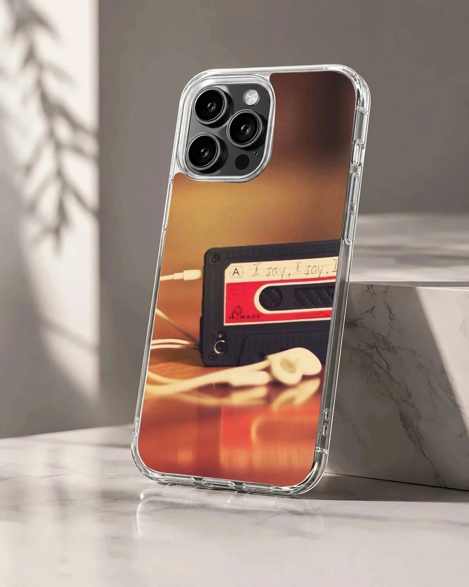 Vintage cassette tape with wired earbuds on a warm surface printed on a phone case
