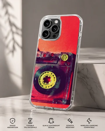 Close-up photograph of a vintage translucent red cassette tape with yellow reels on a phone case — Specs