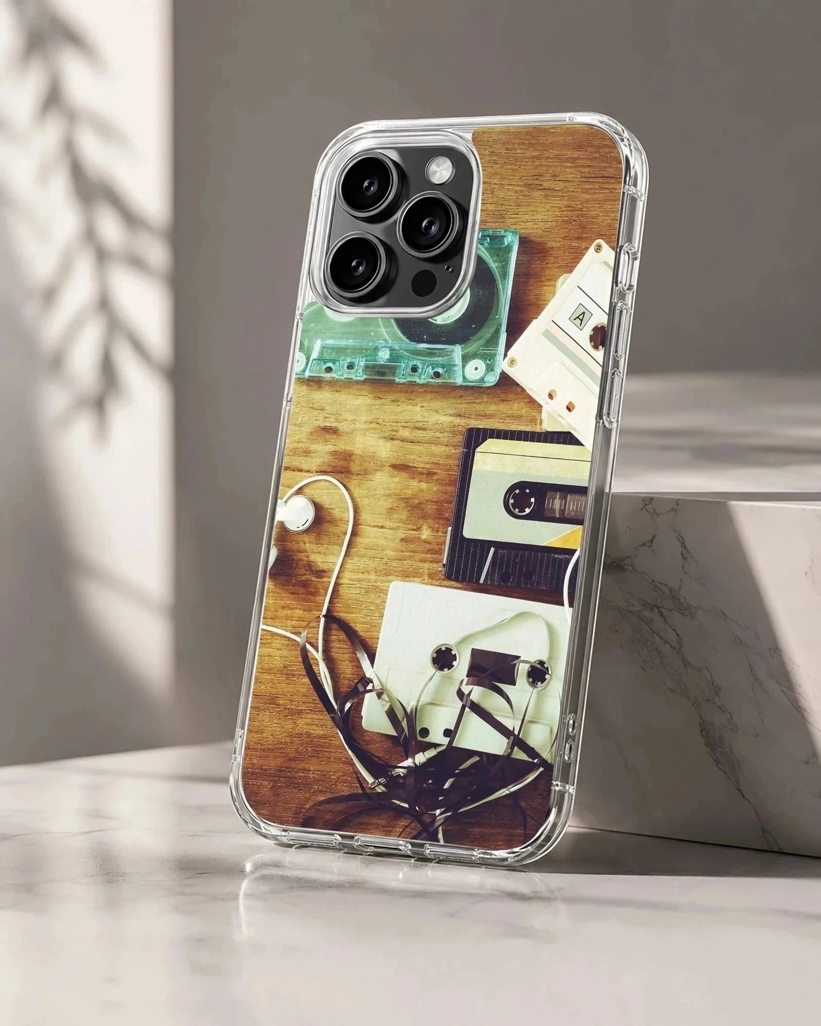 Retro cassette tapes and tangled ribbon on a wooden table phone case