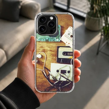 Retro cassette tapes and tangled ribbon on a wooden table phone case — Lifestyle