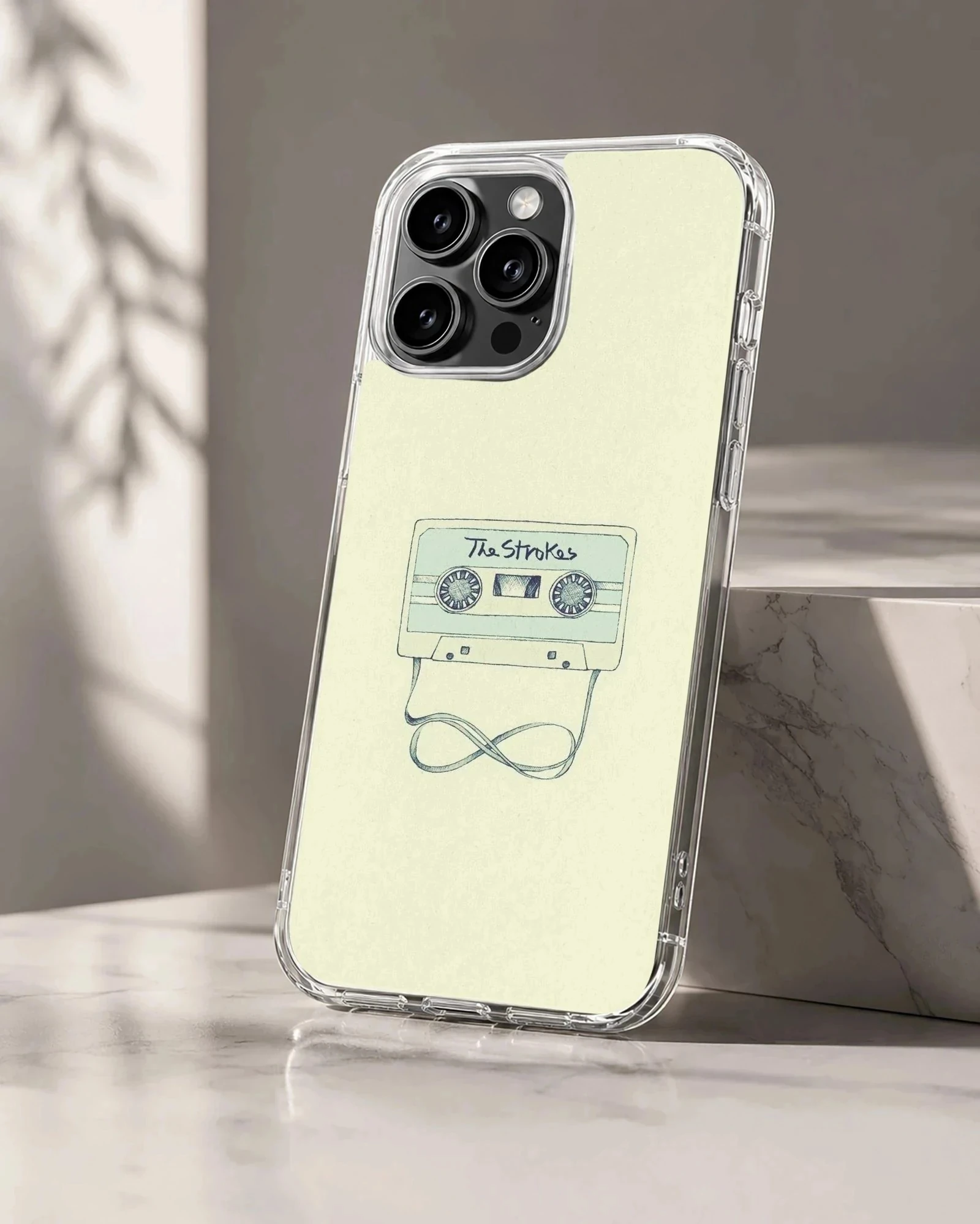Illustrated vintage cassette tape with looped ribbon on a light yellow background phone case