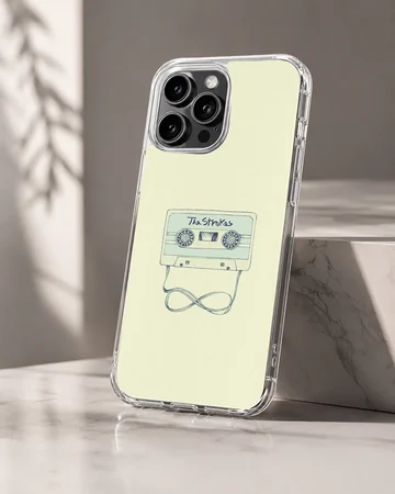 Illustrated vintage cassette tape with looped ribbon on a light yellow background phone case — Hero