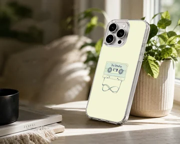 Illustrated vintage cassette tape with looped ribbon on a light yellow background phone case — Lifestyle