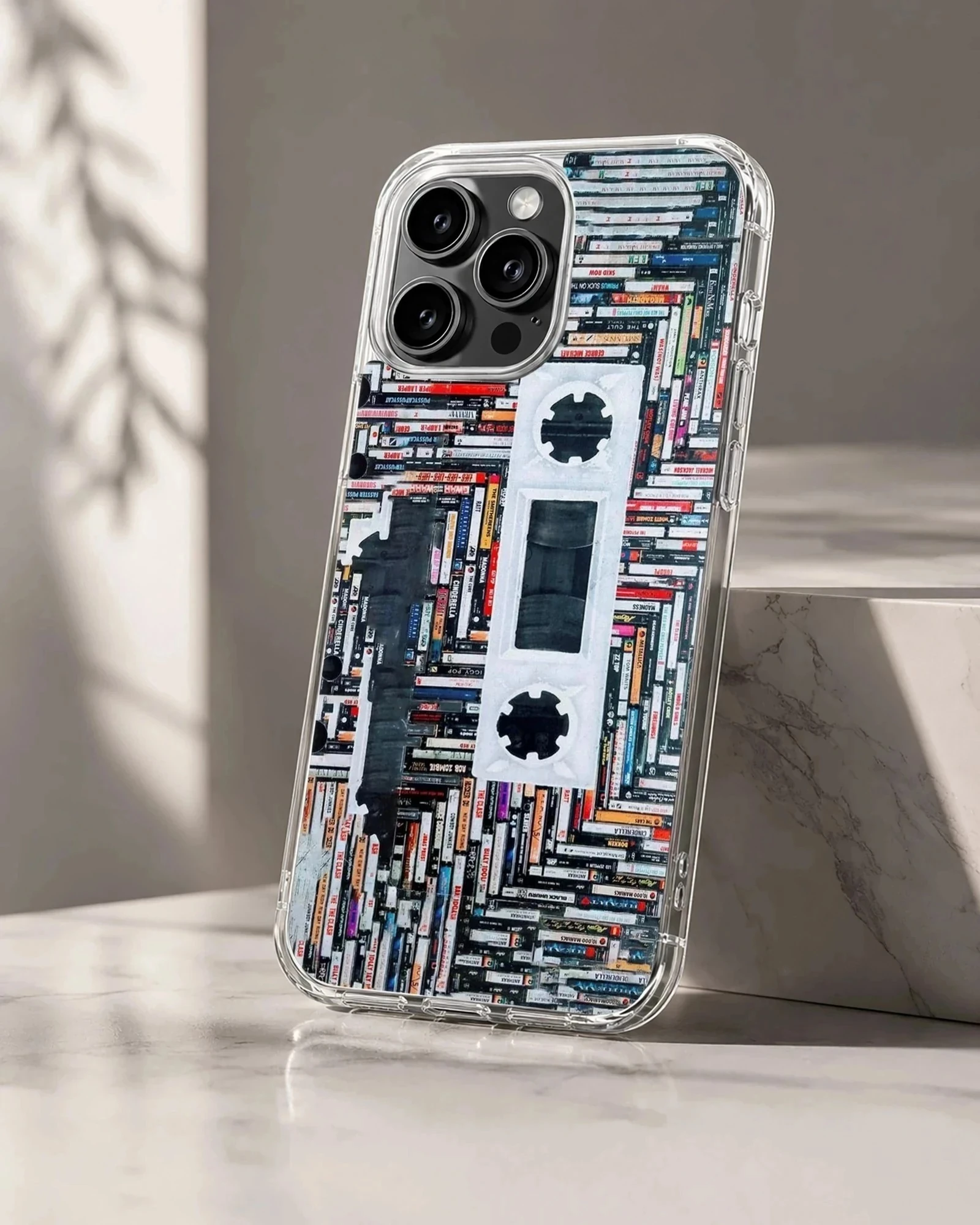 A detailed print of stacked cassette tapes forming a large retro cassette silhouette on a phone case