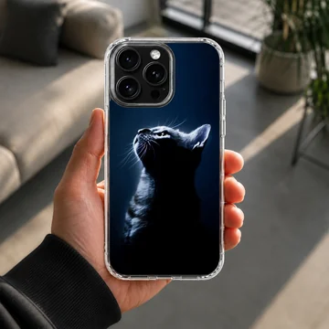 A detailed photographic print of a black cat in silhouette against a dark blue background on a phone case — Lifestyle