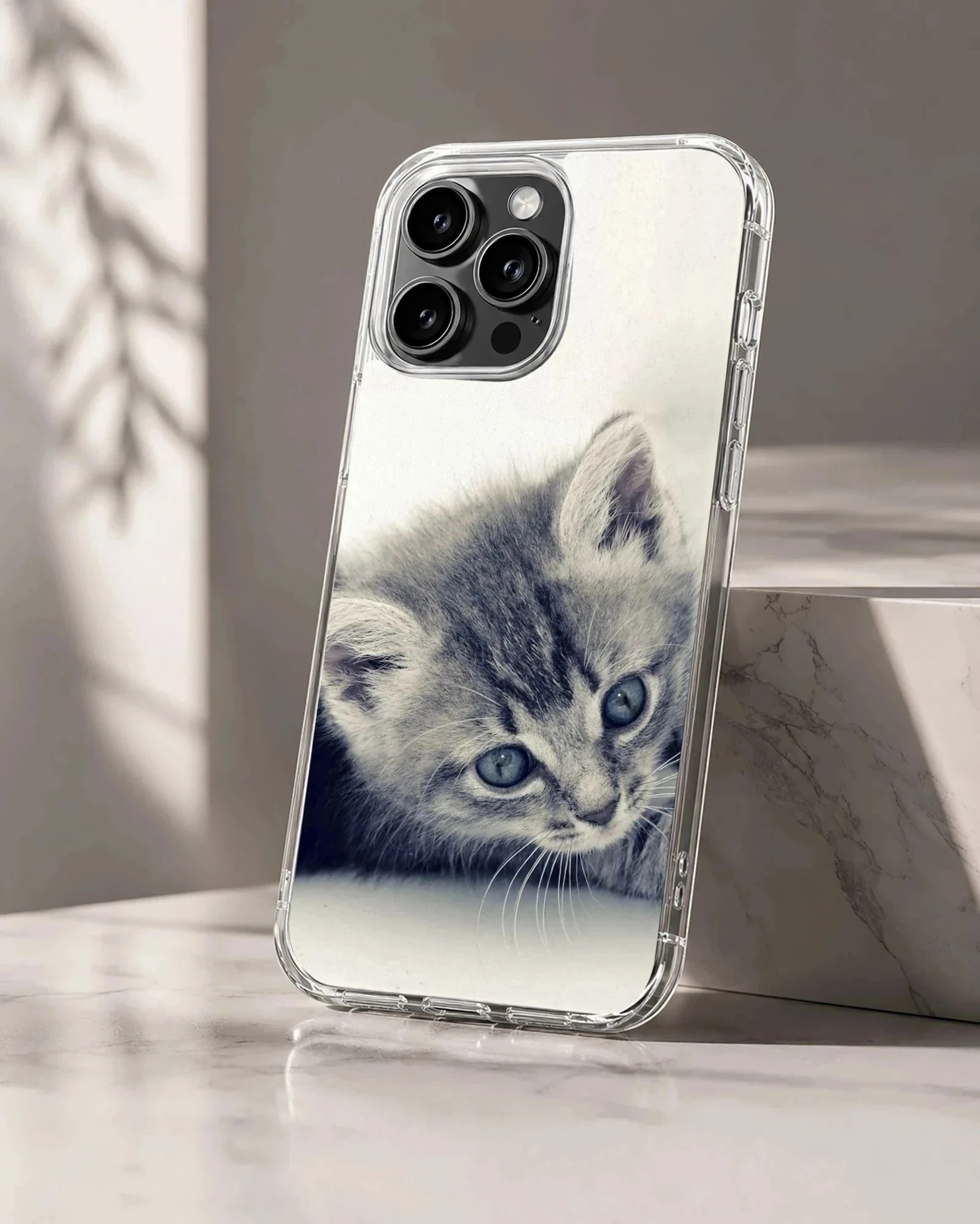 Close-up black and white photography of a sleepy tabby kitten with soft whiskers on a phone case