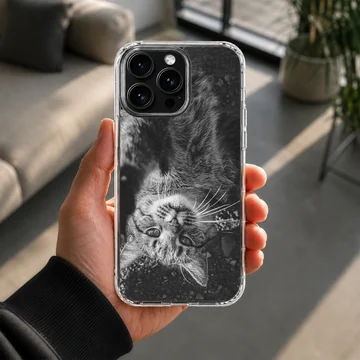 Black and white photographic print of a fluffy cat looking upside down on a phone case — Lifestyle