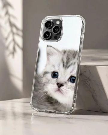 Close-up photographic print of a fluffy grey kitten with wide blue eyes on a phone case