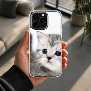 Close-up photographic print of a fluffy grey kitten with wide blue eyes on a phone case — Lifestyle