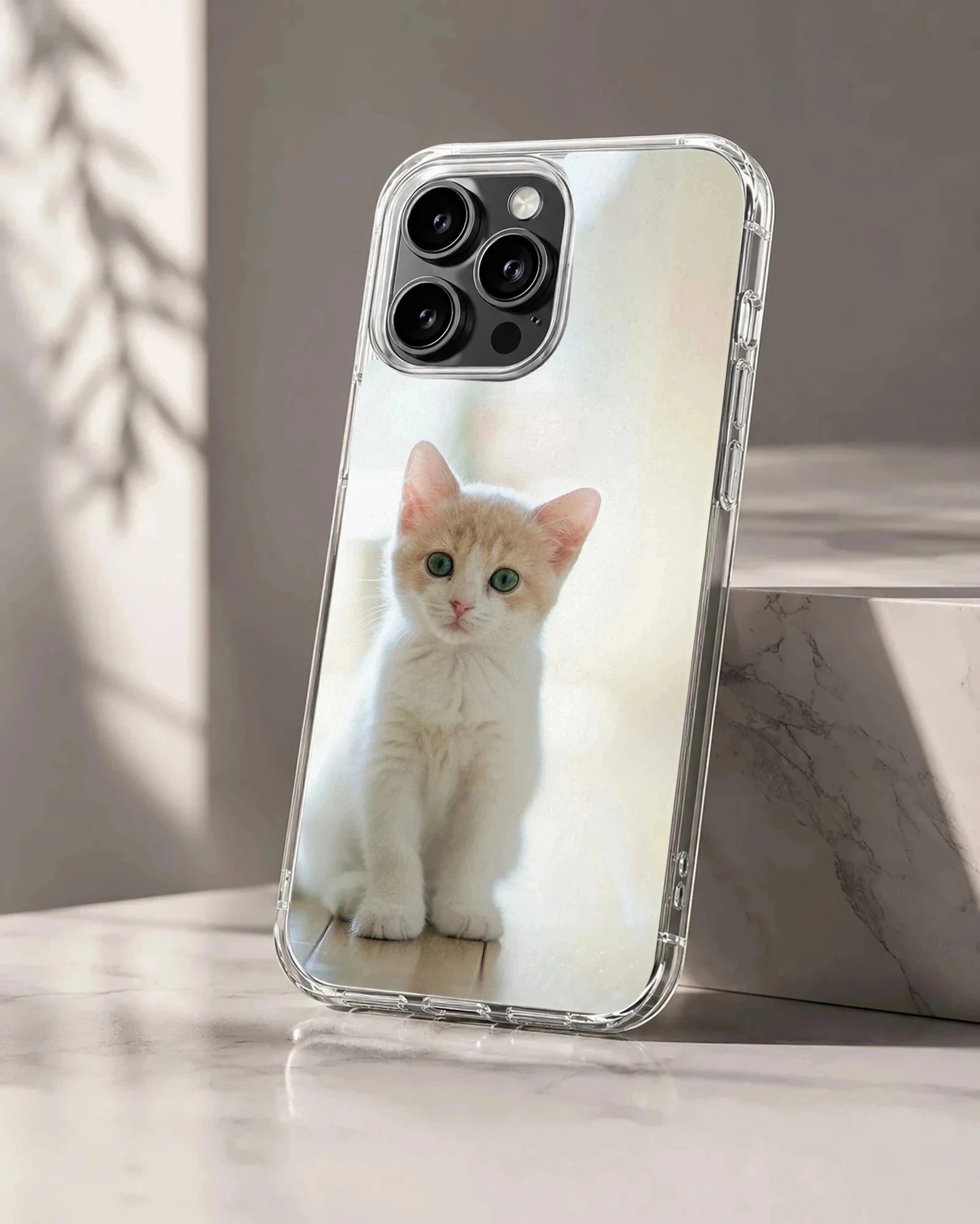 Close-up photographic print of a small white and ginger kitten sitting attentively on a light floor for a phone case