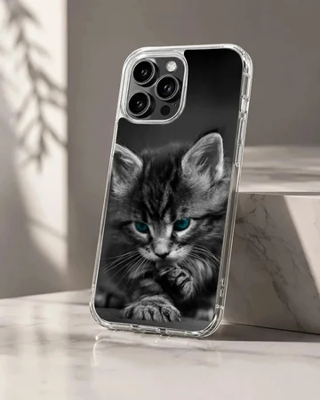 Close-up black and white photograph of a fluffy kitten with striking blue eyes on a phone case