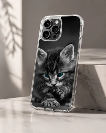 Close-up black and white photograph of a fluffy kitten with striking blue eyes on a phone case — Hero