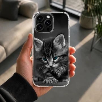 Close-up black and white photograph of a fluffy kitten with striking blue eyes on a phone case — Lifestyle