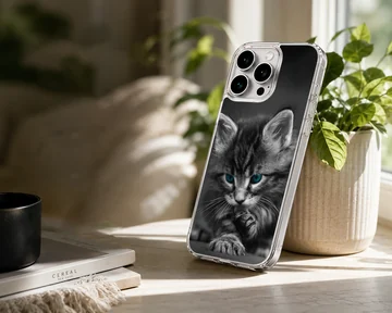 Close-up black and white photograph of a fluffy kitten with striking blue eyes on a phone case — Lifestyle