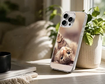 Close up photo of an adorable tabby cat lying on its back on a phone case — Lifestyle
