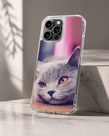 Close-up photographic print of a grey cat with bright amber eyes on a phone case — Hero