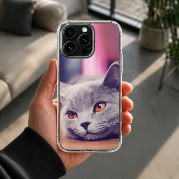 Close-up photographic print of a grey cat with bright amber eyes on a phone case — Lifestyle
