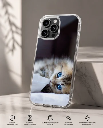 A fluffy kitten with striking blue eyes peeking from under a white blanket on a phone case — Specs