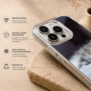 A fluffy kitten with striking blue eyes peeking from under a white blanket on a phone case — Info